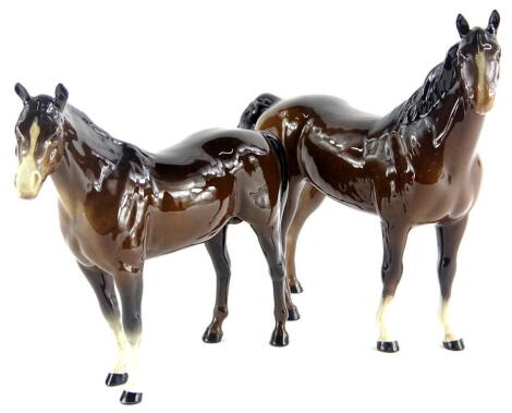 A Beswick horse, brown colourway, white face, standing, printed marks beneath, 20cm high and another head right (2).