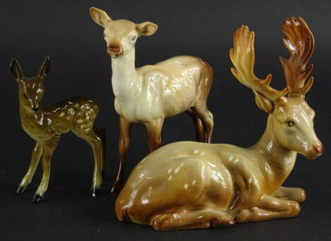 A Beswick recumbent stag, number 954, 18cm wide, a standing doe and a further fawn, unmarked (3).