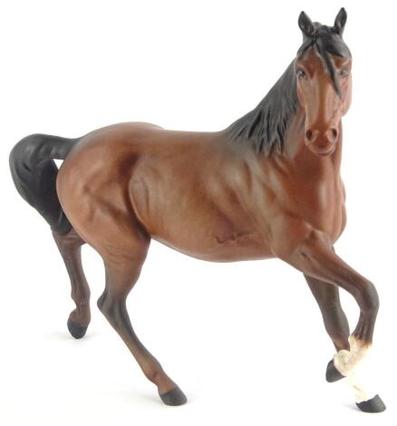 A Royal Doulton trotting horse, matt, right leg raised, head right, printed marks beneath, 22cm high.