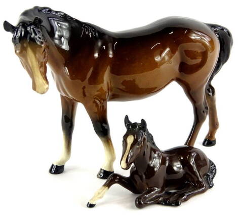 A Beswick horse, brown colourway, head right, standing, 17cm high and a recumbent foal, 915, marks beneath (2).