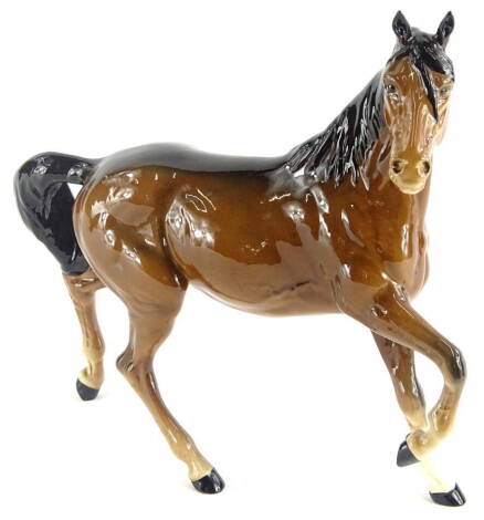 A Royal Doulton trotting horse, right leg raised, head right, printed marks beneath, 22cm high.