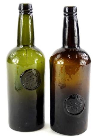 Two green glass bottles, each with seal mark for Longhills.