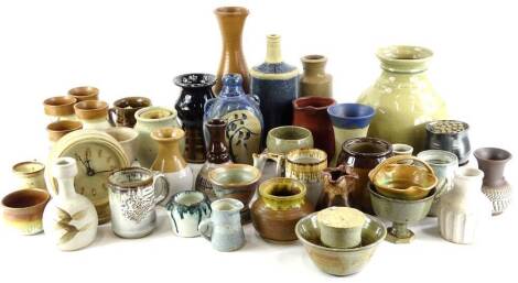 A large collection of Studio pottery, to include an alarm clock, a Mary Pancost carafe with three goblets, etc.