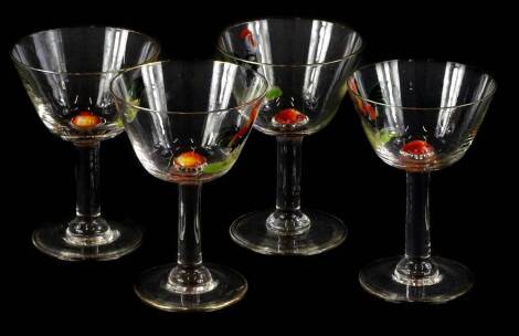 A set of four early to mid 20thC continental cocktail or wine glasses, each of tapering form, painted with a cockerel and also centrally with an apple, 11cm high.