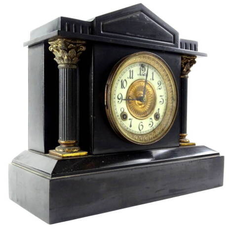 A late 19thC French style black slate and gilt metal portico shaped clock, the enamel style dial stamped for the Ansonia Clock Company of New York USA, 36cm wide.