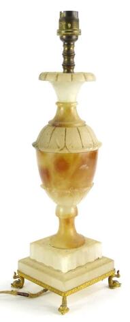 A late 19th/early 20thC continental alabaster table lamp, of baluster form, carved with leaves and with gilt metal mounts, 38cm high.