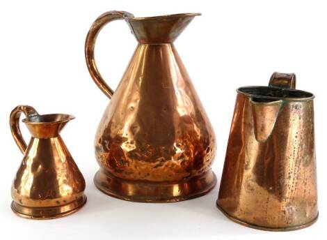 A 19thC copper flagon (AF), 29cm high, a small flagon and another similar (3).