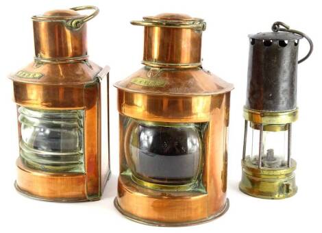 A pair of ship's copper and brass port and starboard lanterns, 26cm high and a brass and steel miner's lamp.