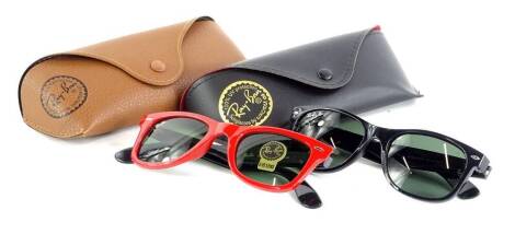 Two pairs of Ray-Ban sunglasses, with red and black frames and metal rims with tinted red lenses, each with carrying case, with original boxes.