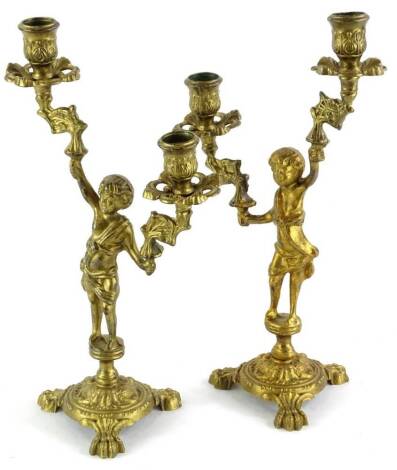 A pair of continental gilt brass two branch figural candelabra, 32cm high.