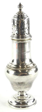 A George V silver baluster shaped sugar castor, with turned finial, domed foot, Chester 1930, 3½oz, 17cm high.