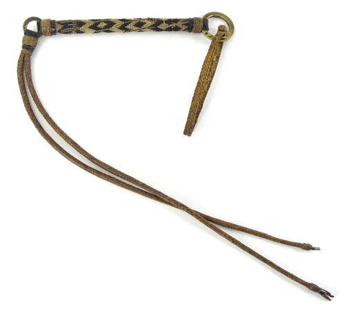 An African woven horse or animal whip, with cast brass washer, etc., 87cm long.