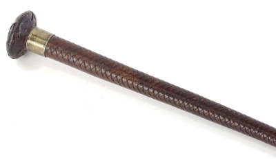 A woven leather riding crop, with silver collar stamped Champion and Wilson London, marks indistinct.