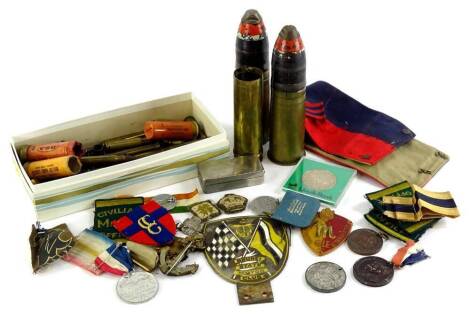 A collection of militaria, to include some cloth badges for Civilian Mil Gov, commemorative medals, Brunei State motor club enamel badge, various spent brass cartridges, etc.