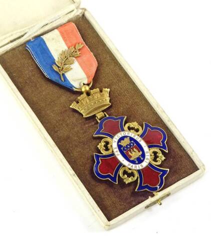 An early 20thC French gilt metal and enamel medal, stating the motto Pax Victorious etc., 1919, the ribbon decorated with a laurel sprig, in original cream canvas fitted case.