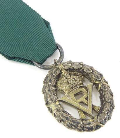 A Victorian silver Volunteer Officers medal or decoration, with green ribbon, awarded for long service, etc.