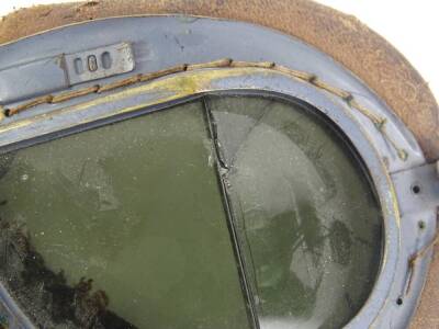 A pair of flying goggles, grey painted onto a brass, with leather coated padding, glass (AF). - 2