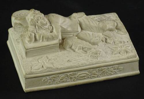 A 19thC French clay sculpture, modelled in the form of a reclining Huntsman with a dog, tablet mark underside.