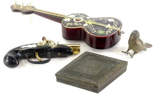 A souvenir simulated tortoiseshell novelty guitar music box (AF), a set of base metal lozenge shaped ashtrays in fitted case and a cold painted bird, a flintlock type Japanese cigarette lighter (4).