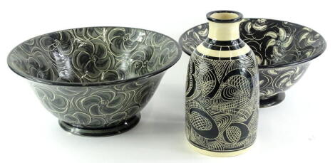 Three items of Studio Pottery by B Frith, to include two bowls with flower head design, white, grey and black, signed to underside and a similar vase with sgraffito decoration.