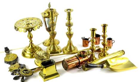 A large quantity of brass and copper, to include fire irons, candlesticks, telescope, trivet, table lamp etc.