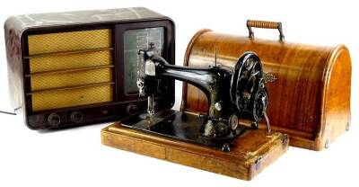 A Singer sewing machine, in a walnut case and Bakelite radio (AF).