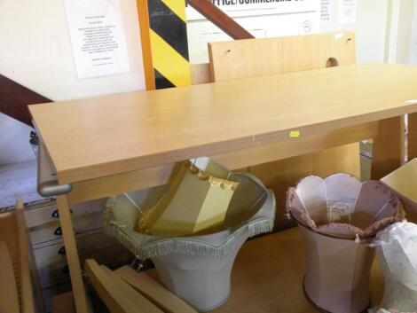 A modern corner desk with three drawers and another desk