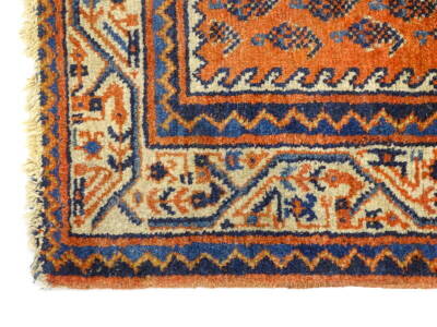 A Persian rug, with a design of botei, on a red ground with one wide and two narrow borders, 103cm x 146cm. - 2
