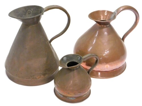 Three late 19th/early 20thC copper flagons, various sizes, the largest 37cm high.