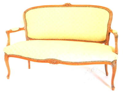 A early 20thC French style beech sofa, with a moulded frame, with flowers, with padded back arm rests and seat upholstered in gold damask fabric, on cabriole legs, 143cm wide.