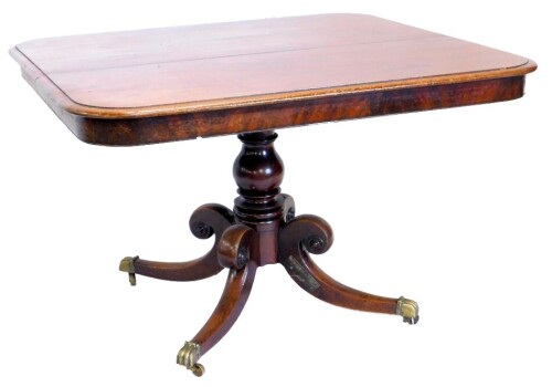 An early 19thC mahogany breakfast table, the rectangular top with a moulded edge on a turned column and four splayed legs with brass castors, the top 102cm x 113cm.