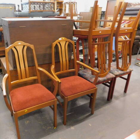 A set of four teak Nathan dining chairs, and two associated armchairs (6). The upholstery in this lot does not comply with the 1988 (Fire & Fire Furnishing) Regulations, unless sold to a known exporter or upholsterer it will be cut from the frame before l