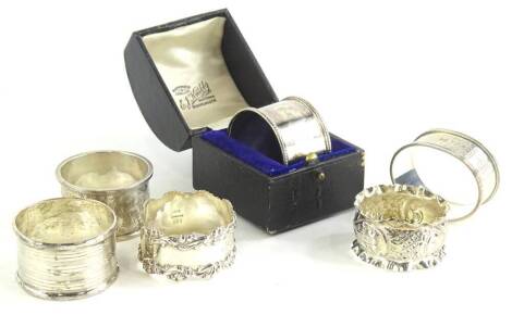 A collection of six various silver napkin rings, of differing design and date, 4¾oz, one cased.