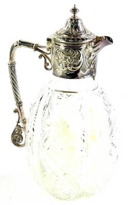 A late Victorian cut glass and silver mounted claret jug, with a faceted body, the mount decorated with scrolls, leaves, etc., the handle with pierced gothic style decoration, Sheffield 1898, 28cm high.