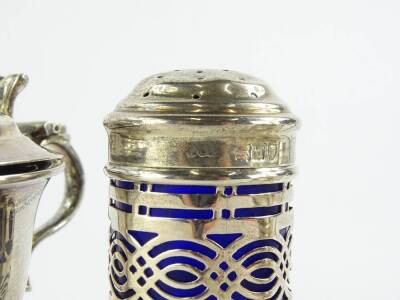 A collection of small silver, to include a circular mustard pot with domed lid and shaped thumb piece, Birmingham 1930, another mustard pot and a pepper pot, each with a blue glass liner, silver weight 5½oz. - 2