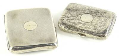 A late Victorian silver cigarette case, with stippled decoration, surrounding a circular vacant cartouche, Chester 1896 and another similar, Birmingham 1920, engraved with initials RCB, 5¼oz.