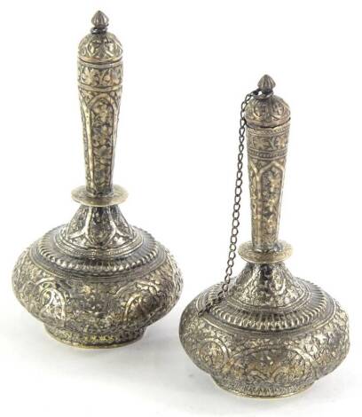 A pair of incense bottles, each heavily decorated with panels of flowers, with removable stoppers, and a bead border to the bellied body, on circular feet, unmarked, 12cm high (2).