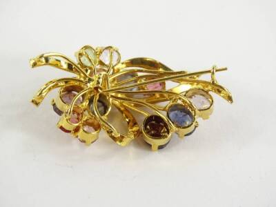 A costume jewellery brooch, set in the form of a floral spray, with multi coloured pink and purple stones, on a gold plated surround, 4cm long overall. - 2