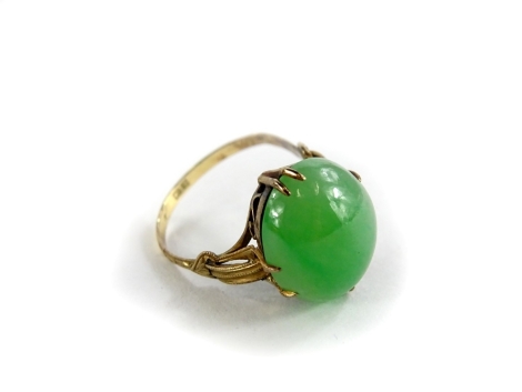 A jade set dress ring, with oval cabochon type cut pale green jade stone, 15mm x 12.2mm x 5.8mm, on a fine yellow metal wirework Victorian style setting, stamped 18K, ring size M, boxed, 4g all in.