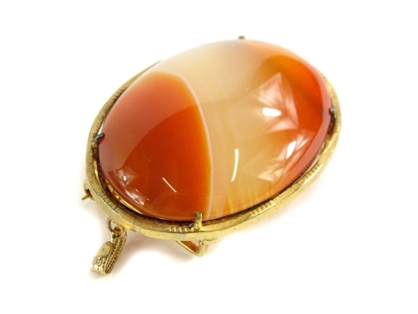 A gold framed agate set pendant/ brooch, the oval orange and white set agate in a yellow metal fine work frame, unmarked, with adaptation to a brooch or a pendant, 4.5cm x 3.5cm, 17.1g all in.