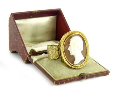 A late 19thC shell cameo bangle, with conversion links for a brooch and a pendant, the cameo depicting a male head and shoulders portrait looking left and bearing signature S Auline?, in heavily scrolled yellow metal coloured setting, possibly silver gilt