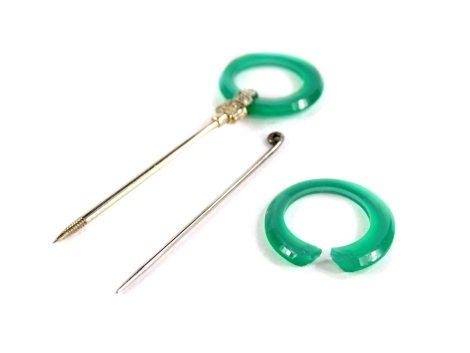 A 14ct white gold jade set pin, the 14ct gold pin with etched design loop holding a circular jade ring, a further jade ring (AF), and a single pin, in Cartier of Paris, London, New York box.