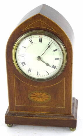 An Edwardian mahogany and inlaid mantel clock, of lancet shape, with French painted dial and brass movement, on brass bun feet, 23cm high.