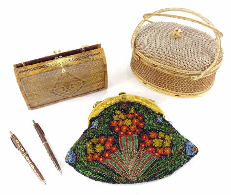 A collection of ladies bags etc., to include a beadwork example with ivorine clasp, moulded with Egyptian motifs, a straw work bag and a similar embroidered Eastern bag or box (3).