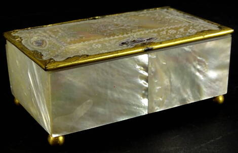 A late 19thC continental mother of pearl jewellery box, with gilt metal mounts, engraved with flowers etc., padded interior on ball feet, 13cm wide.