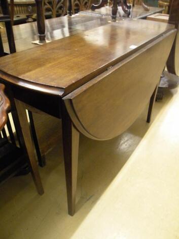 A mahogany oval drop leaf table