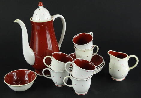 A Susie Cooper bone china part coffee service, decorated with red and white spots, to include coffee pot, milk jug, sugar bowl, cups and saucers.