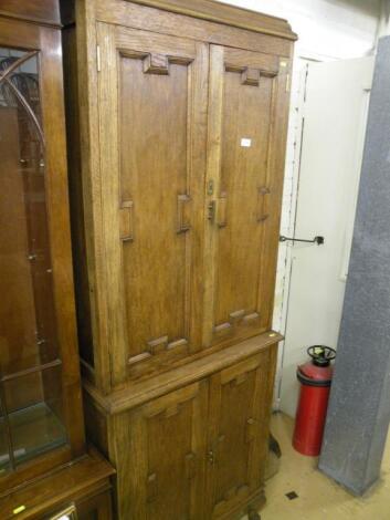 An oak cupboard with two pairs of panel doors