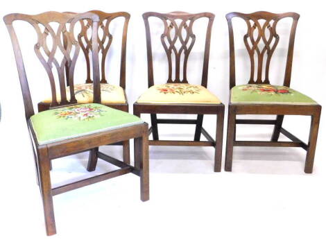 A set of four George III mahogany dining chairs, each with a pieced splat, a drop in seat and chamfered legs.