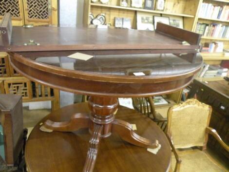 A Continental mahogany extending dining table with one loose